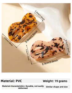 Detailed view of turtle shell and light pink spotted PVC hair claw clips in figure 8 design