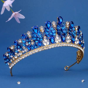 Elegant bridal crown with blue and clear crystals on a gold base for wedding hair style