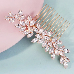 Elegant gold hair comb with leaf-shaped marquise-cut zircons for bridal wedding hairstyle