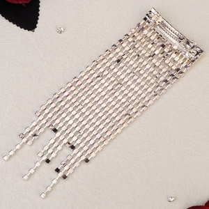 Macro view of crystal rhinestone tassel hair clip with silver alloy fringe chains