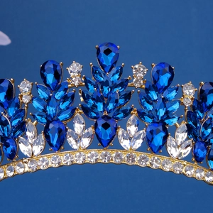 Detailed macro view of luxurious blue crystal crown with intricate golden alloy setting