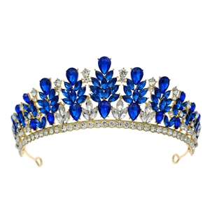 Detailed macro view of sparkling blue and clear crystals on a golden bridal crown