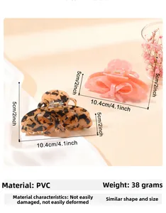 Detailed size specifications for bow-shaped hair claws in tortoiseshell and pink marble patterns