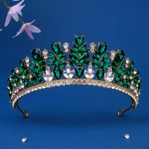 Detailed view of emerald green crystal crown with golden metal frame for brides