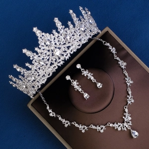Detailed close-up of luxury bridal crown, necklace and earrings set in a jewelry box