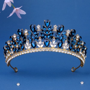 Close-up of golden bridal crown featuring blue teardrop crystals and sparkling gems