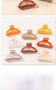 Macro view of assorted semi-circular claw clips in various matte and glossy pastel colors