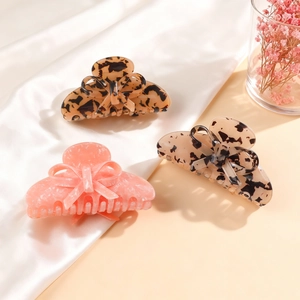 Three-piece acetate bow hair claw set in tortoiseshell, beige, and pearl pink marble