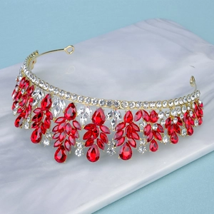 Close-up of luxury bridal crown with red teardrop crystals and gold alloy base
