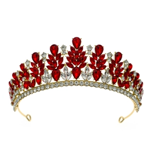 Luxurious baroque bridal crown with red and white crystals on a gold alloy base