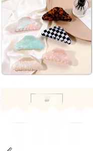 Detailed close-up of colorful large acetate hair claws in marble and checkered patterns