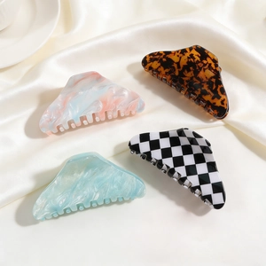 Elegant acetate hair claws in marble, tortoiseshell, and checkerboard patterns for women