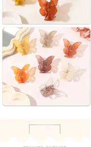 Detailed view of colorful butterfly hair claws in amber and cream on a ceramic tray
