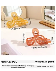 Macro view of transparent PVC bow hair claw clip in amber yellow with precise dimensions