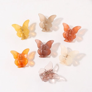 Set of 7 colorful translucent butterfly hair claws in various shades for daily styling