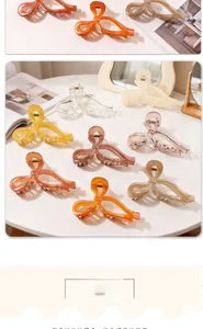 Close-up of large acrylic bow hair claws in various colors on a minimalist white table