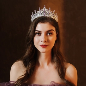 Elegant silver bridal tiara crown with purple gemstones and crystals worn by a model