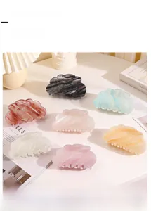 Detail showing seven colors of dream gradient cloud-shaped hair claw clips with fine glitter