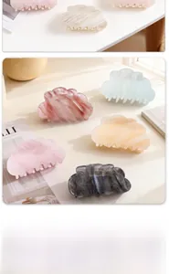 Detail of cloud-shaped marble texture hair claws in various elegant gradient colors