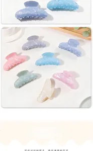 Macro detail of assorted iridescent pearlescent hair claw clips in pastel macaron colors