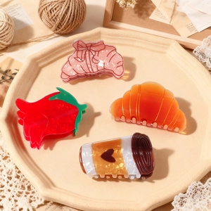 Set of retro croissant and coffee cup hair claws in vintage aesthetic tray arrangement
