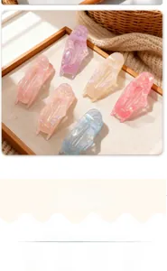 Detail of colorful hollow butterfly hair clips with iridescent frosted texture on a tray