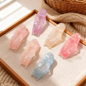 Set of 6 colorful heart-shaped hair claw clips with shimmering iridescent finish in a tray