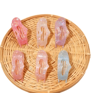 Set of 6 colorful heart-shaped hair claw clips with iridescent finish in a woven tray