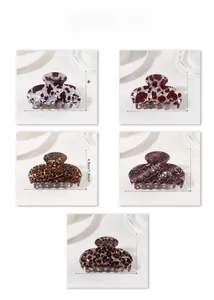 Detailed view of five multi-colored leopard print hair claws with precise size dimensions