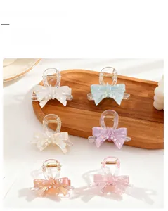 Set of six colorful translucent bow-shaped hair claw clips in elegant macaron shades