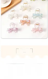 Detailed view of six iridescent bow hair clips in various jelly colors arranged on a table