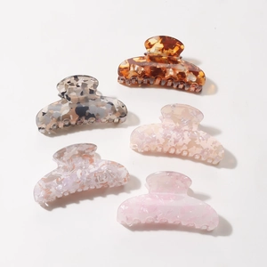 Set of five elegant hair claws with transparent marble textures and diverse color patterns