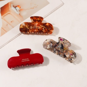 Three elegant French texture hair claws in marble, dark red and tortoiseshell patterns