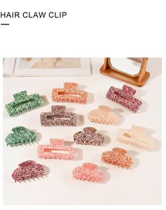 Detail showing twelve colorful hair claw clips with speckled patterns in diverse styles