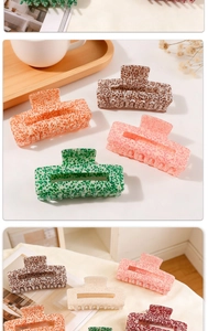 Close-up of marble texture hair claw clips with matte finish and metallic spring