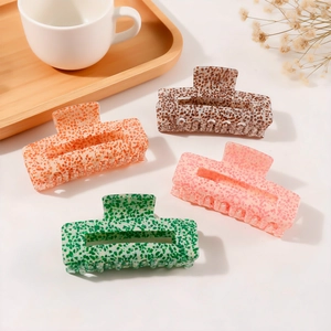 Set of four speckled texture hair claws in orange, brown, pink, and green colors