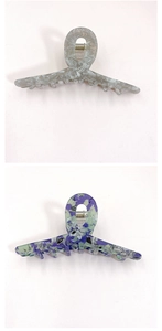 Close-up of marble pattern hair claw clips in grey and purple acetate with metal springs