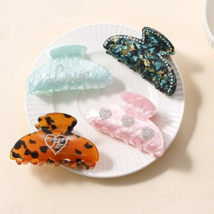 Set of four vintage resin hair claws with rhinestone heart and Love patterns