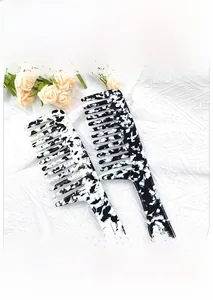 Close-up of wide-tooth tortoiseshell acetate combs with elegant marble patterns