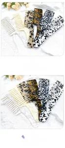 Detail view of long-handle acetate hair combs in marble and tortoiseshell patterns