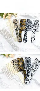Detail view of five wide-tooth acetate combs with vintage tortoiseshell and marble patterns