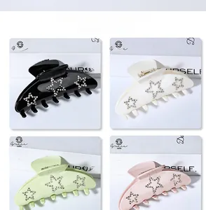 Detail view of 9cm hair clips in four colors with sparkling rhinestone star decorations