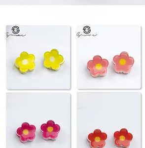 Detailed close-up showing four colors of small resin flower hair clips in 2cm size