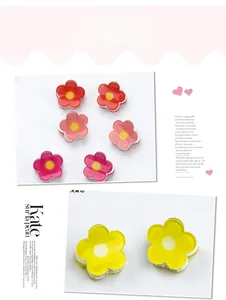 Close-up of 2cm mini flower hair claws in vibrant red, pink and yellow plastic colors