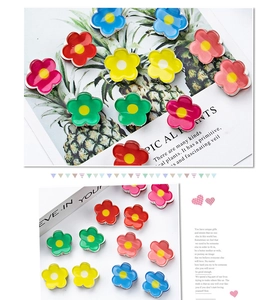 Detailed view of colorful 2cm acrylic flower hair clips with glossy resin finish