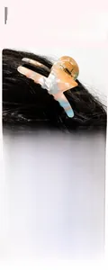Detail of 7cm PVC hair claw clip with orange-blue marble texture and gold spring