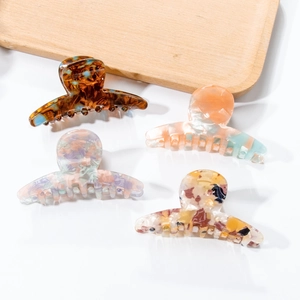 Set of four 7cm PVC hair claw clips in tortoise shell and marble patterns for women
