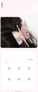 Detailed macro view of pink iridescent butterfly hair claw with strong metal spring