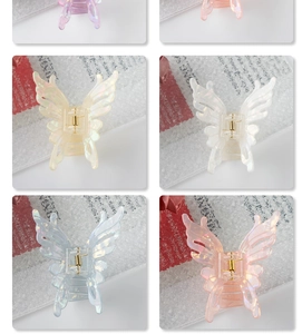 Detail showing butterfly hair claws in iridescent resin with gold metal springs
