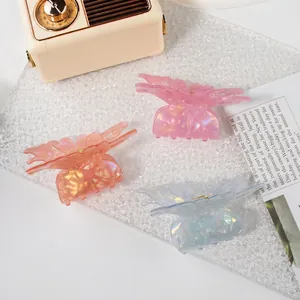 Elegant butterfly hair claws in iridescent colors with golden spring clips